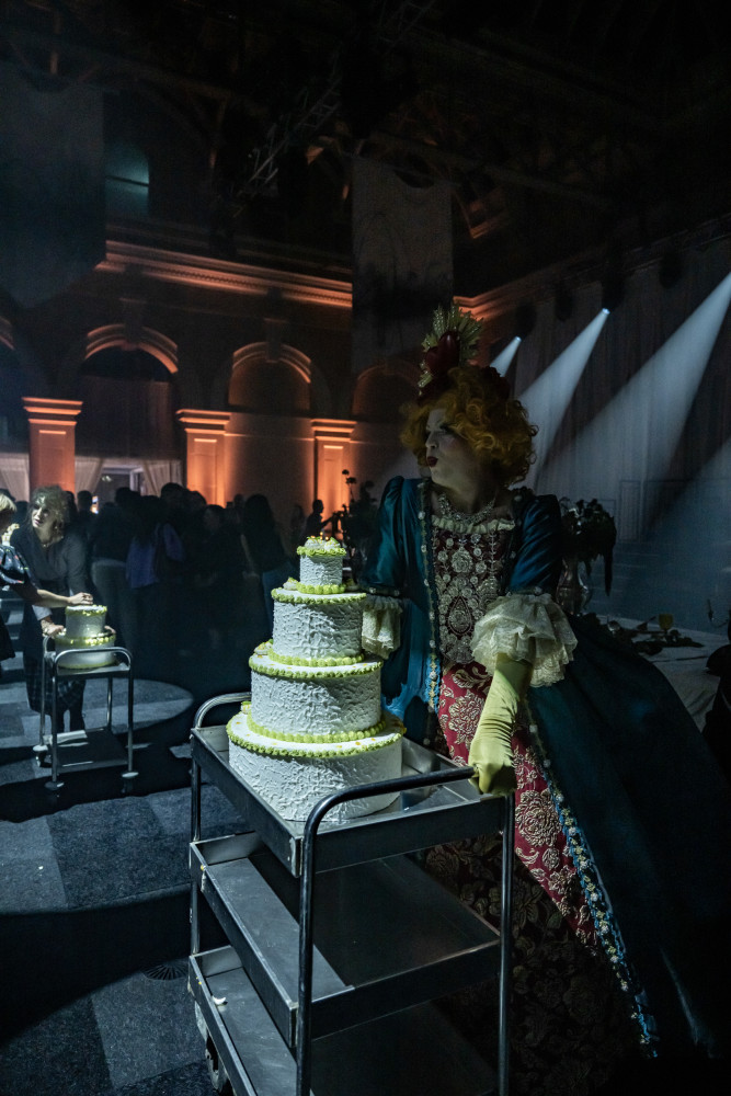 Food and Performance fused- Tiny Desserts delivered on a human conveyor belt